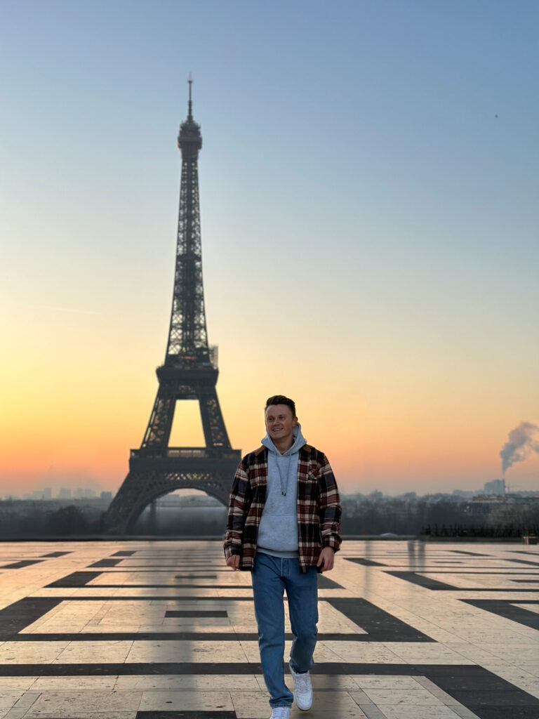 Picture of CJ at Trocadero in front of the Eiffel Tower.